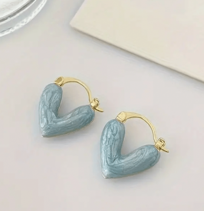 Heart-shaped earrings featuring a pearl accent, crafted from durable metal, showcasing an elegant design perfect for women's fashion. 3