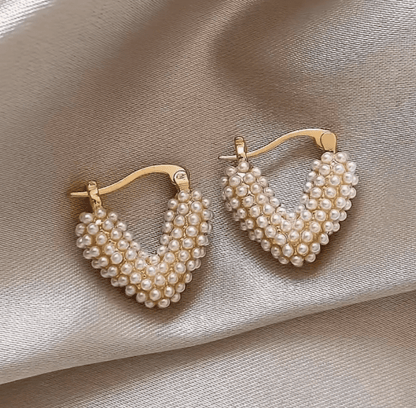 Heart-shaped earrings featuring a pearl accent, crafted from durable metal, showcasing an elegant design perfect for women's fashion. 4