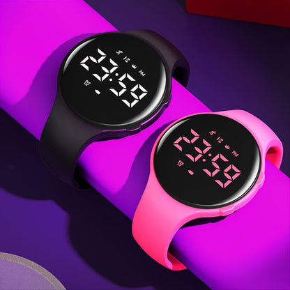 Kids fitness tracker watch in pink with silicone strap, LED display, pedometer, and vibrating alarm for active children. 1