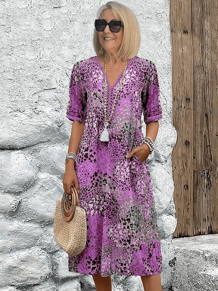Knee-length V-neck summer dress featuring a vibrant floral pattern and convenient side pockets, designed for comfort in plus sizes. 3