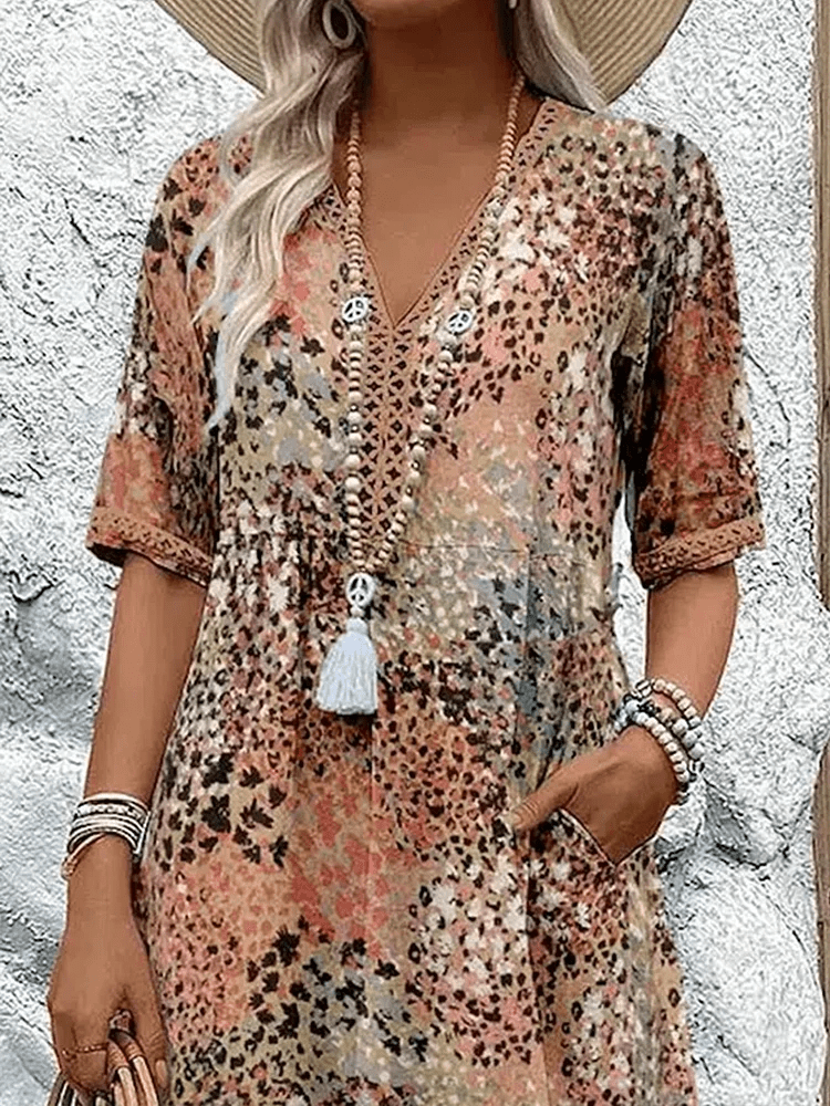 Knee-length V-neck summer dress featuring a vibrant floral pattern and convenient side pockets, designed for comfort in plus sizes. 5