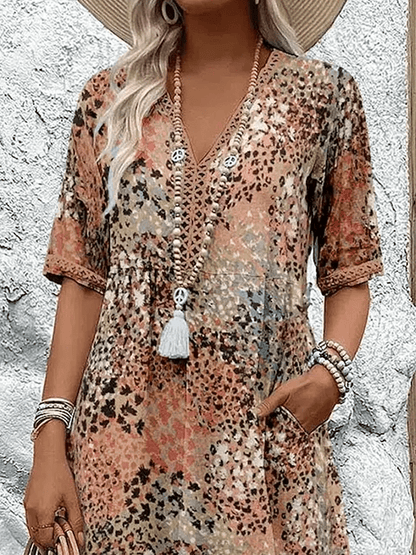 Knee-length V-neck summer dress featuring a vibrant floral pattern and convenient side pockets, designed for comfort in plus sizes. 5