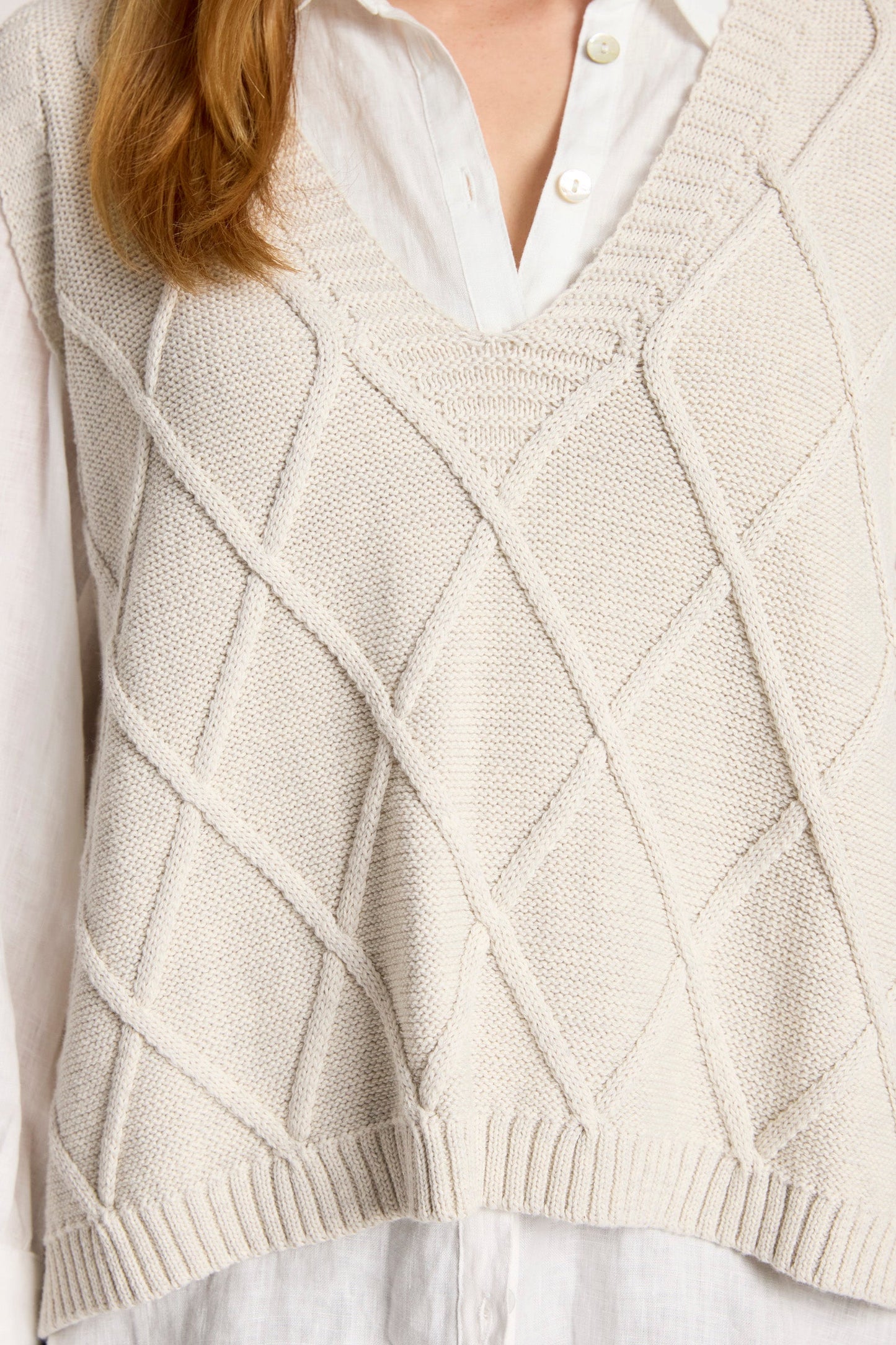 Knit vest featuring a stylish checkerboard pattern and ribbed detailing, designed for women in a soft cotton fabric, with a flattering V-neck, perfect 3