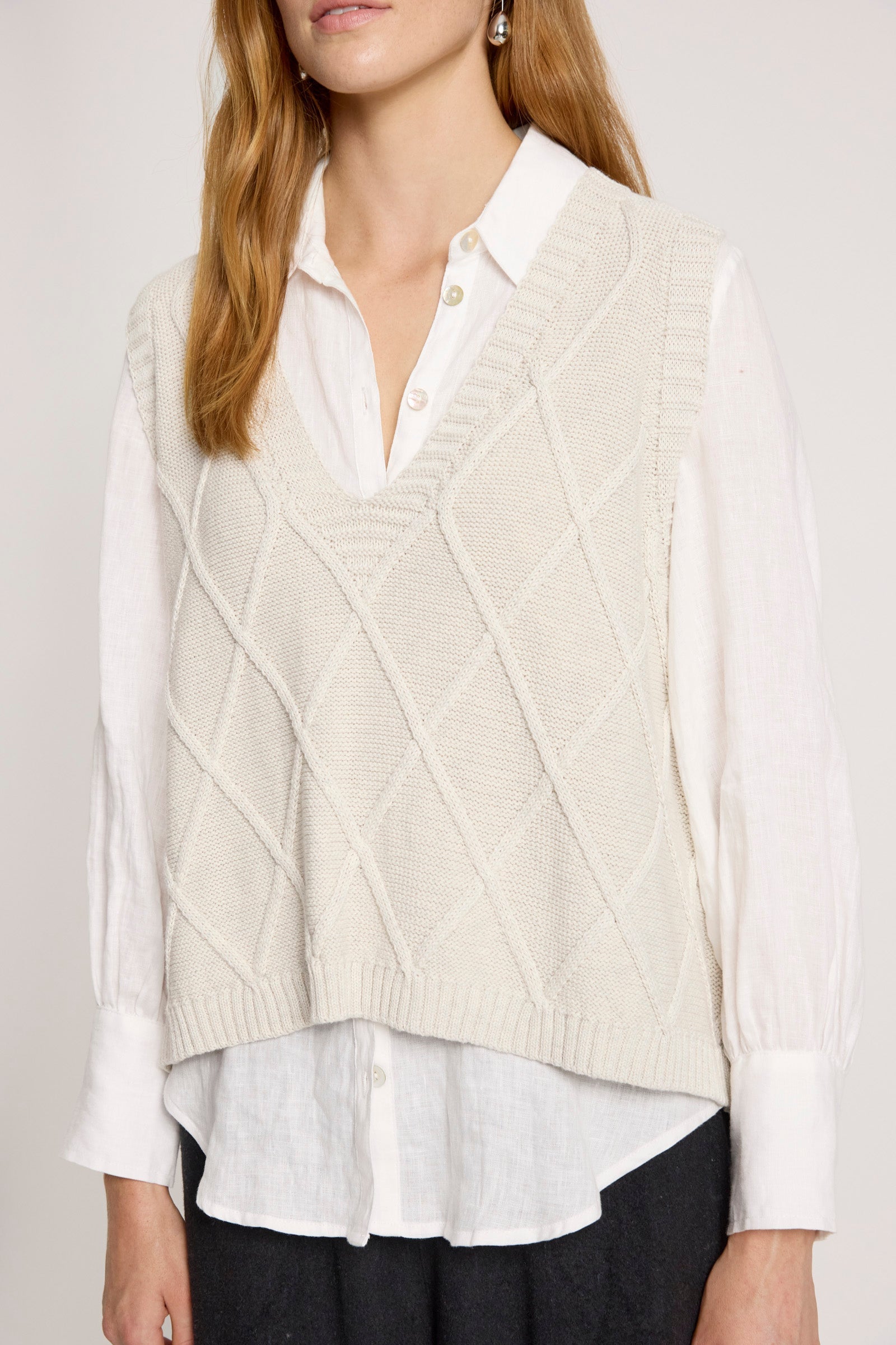 Knit vest featuring a stylish checkerboard pattern and ribbed detailing, designed for women in a soft cotton fabric, with a flattering V-neck, perfect 2