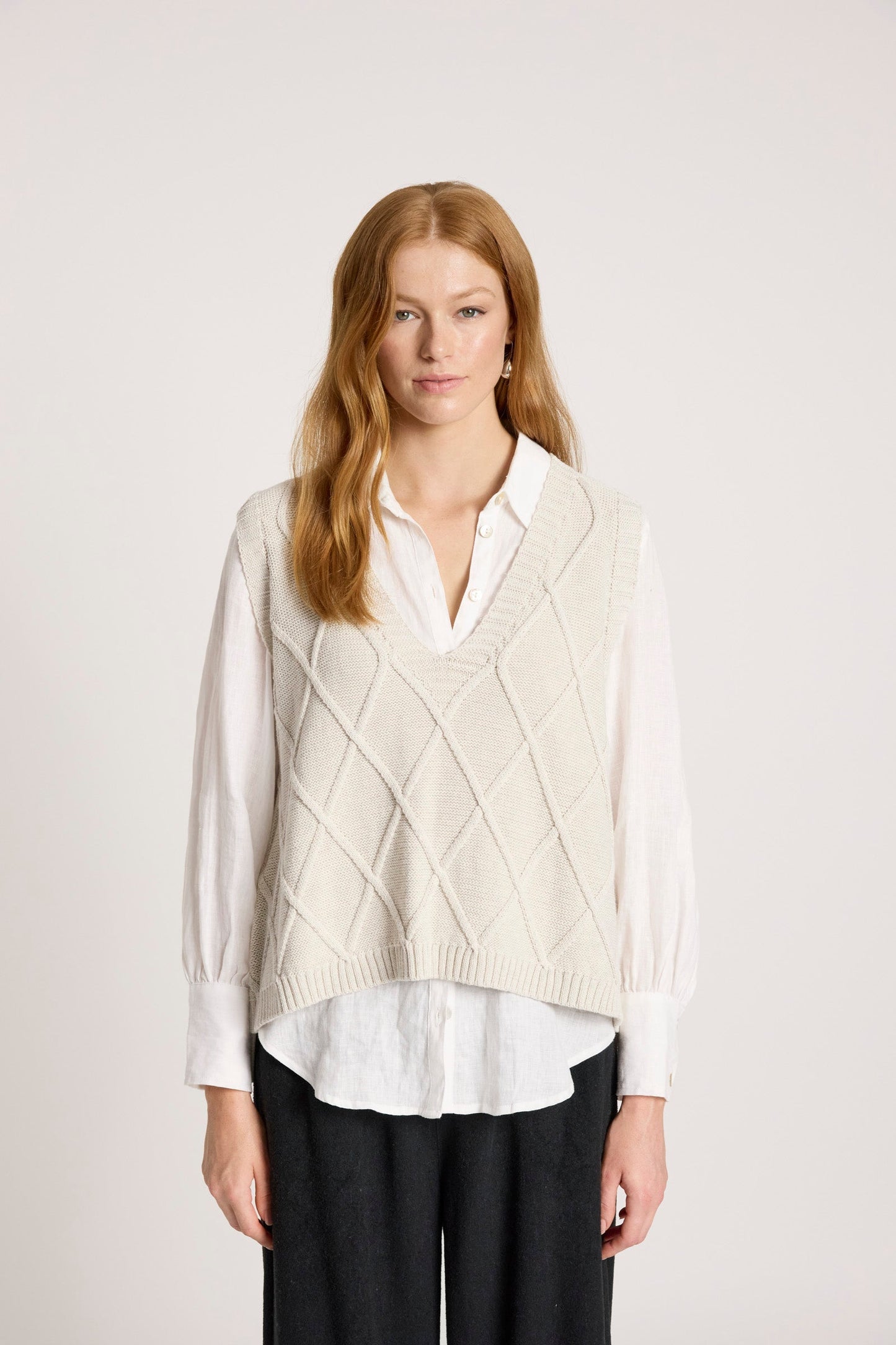 Knit vest featuring a stylish checkerboard pattern and ribbed detailing, designed for women in a soft cotton fabric, with a flattering V-neck, perfect 0