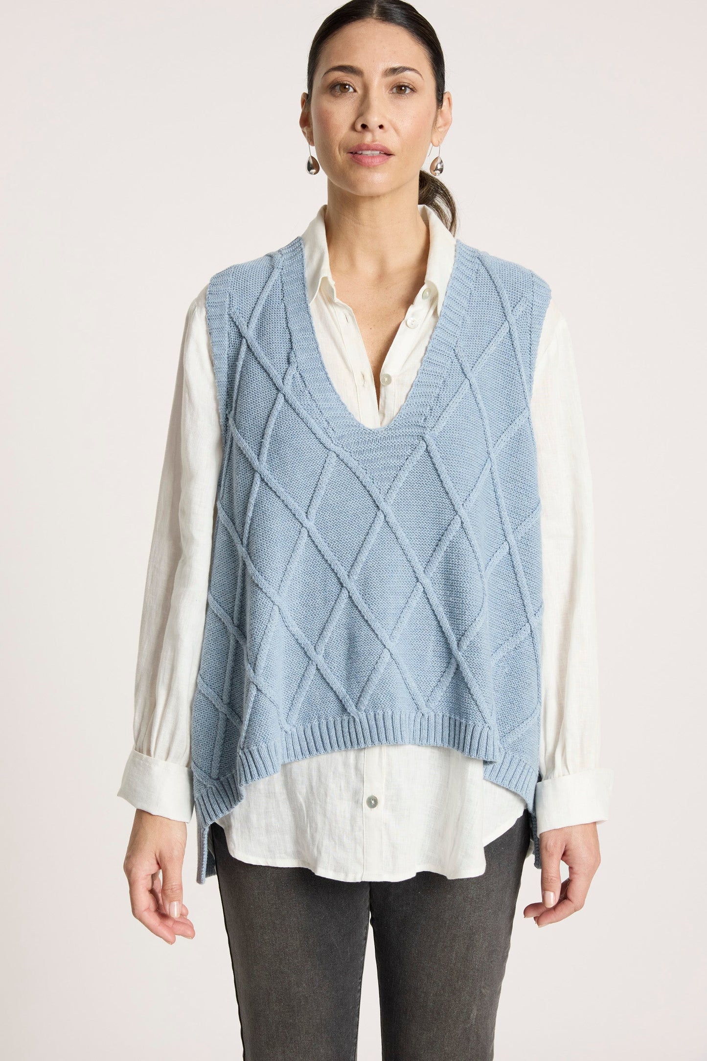 Ladies knitted vest featuring a stylish checkerboard pattern, crafted from breathable cotton with a V-neck design, perfect for layering in any season. 2