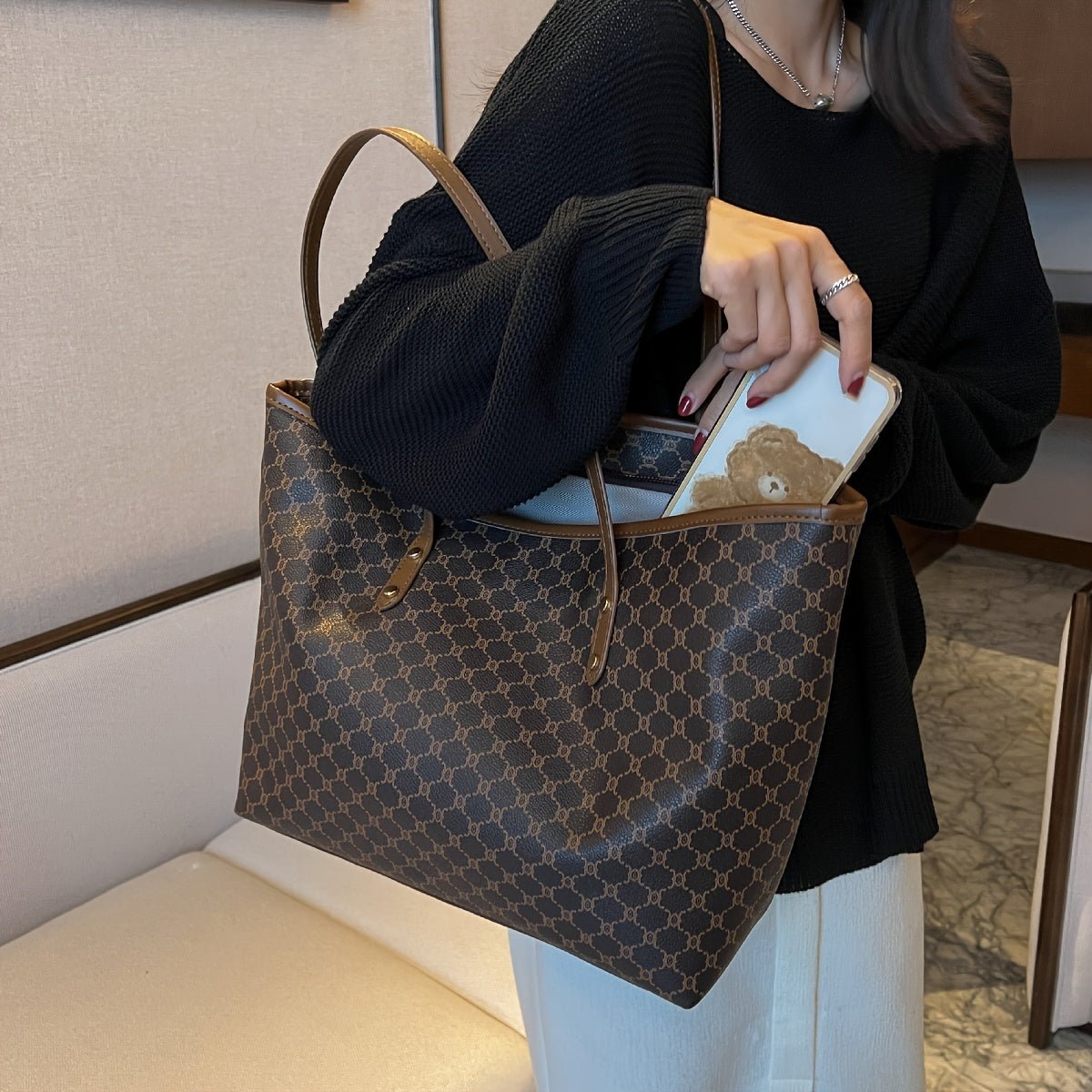 Large black zipper tote bag with shoulder strap, perfect for shopping and travel, featuring spacious interior and stylish design. 8