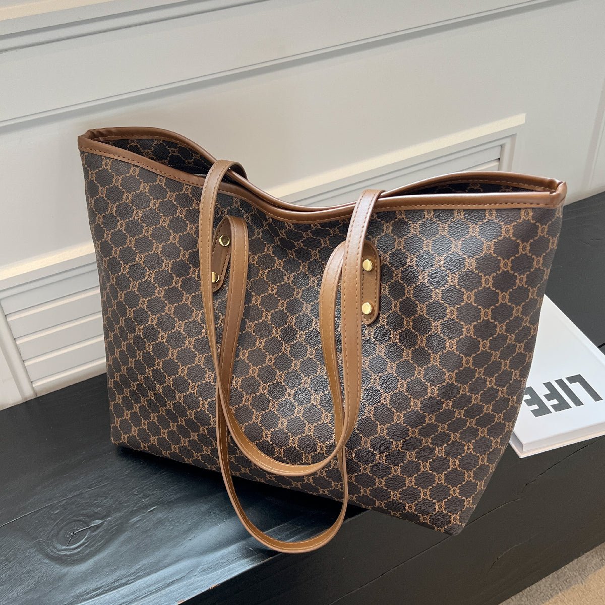 Large black zipper tote bag with shoulder strap, perfect for shopping and travel, featuring spacious interior and stylish design. 1
