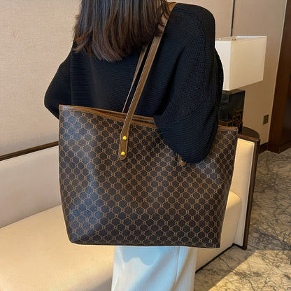 Large black zipper tote bag with shoulder strap, perfect for shopping and travel, featuring spacious interior and stylish design. 0