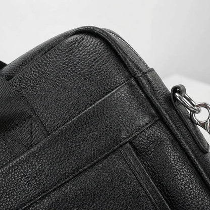 Leather briefcase for men with adjustable strap, featuring a vintage style design in genuine cowhide leather, perfect for carrying laptops and work essentials. 3