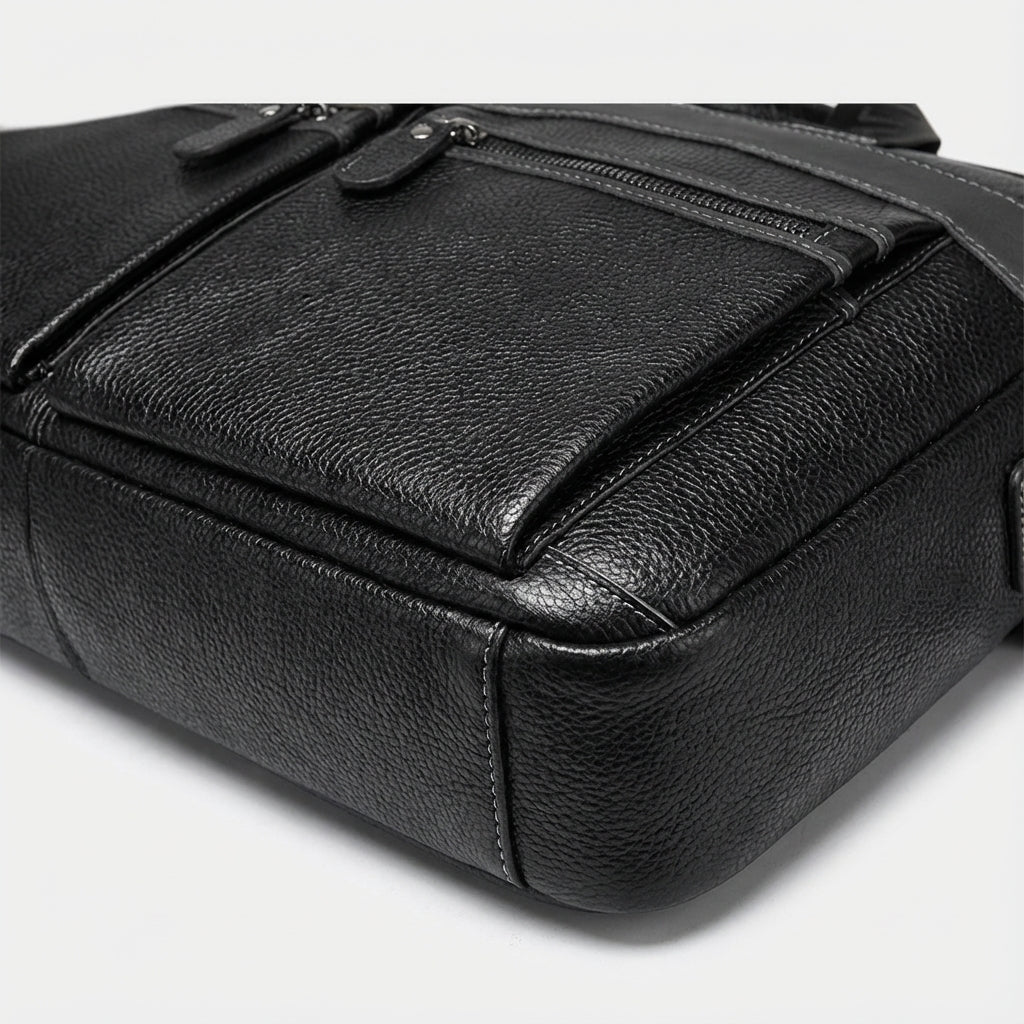 Stylish leather laptop bag designed for 15.6 inch laptops, featuring an adjustable strap and multiple pockets, crafted from high-quality cowhide. 3