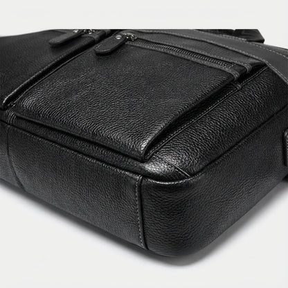 Stylish leather laptop bag designed for 15.6 inch laptops, featuring an adjustable strap and multiple pockets, crafted from high-quality cowhide. 3