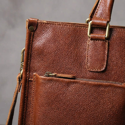 Leather laptop work bag featuring a spacious interior, adjustable strap, and designed to accommodate laptops up to 14 inches. 3