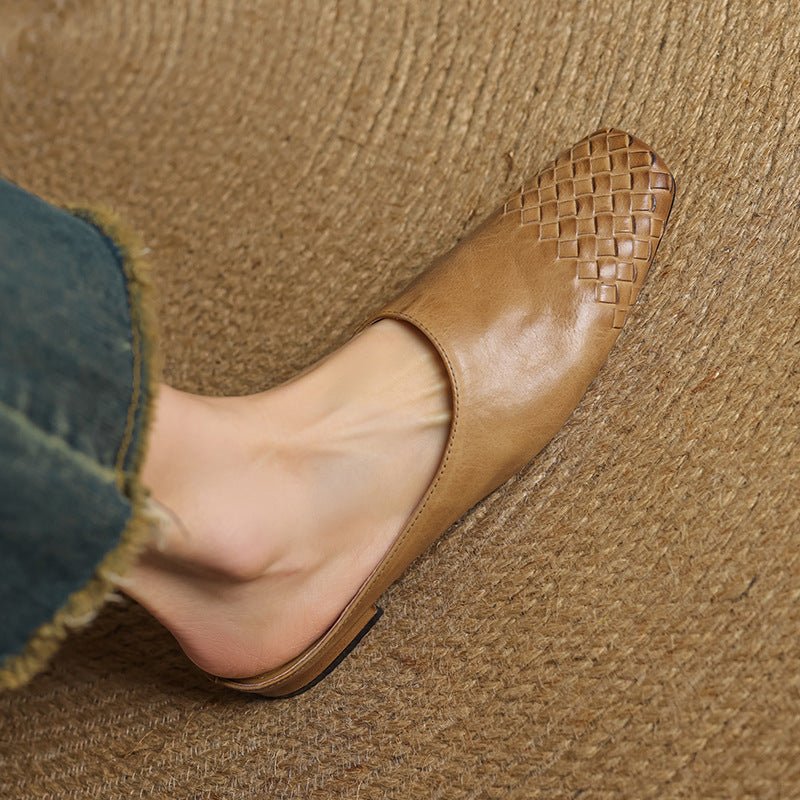 Black leather mules featuring a cushioned insole and woven finish, designed with a square-toe heel for stylish comfort. 1