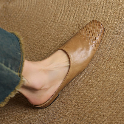 Black leather mules featuring a cushioned insole and woven finish, designed with a square-toe heel for stylish comfort. 1
