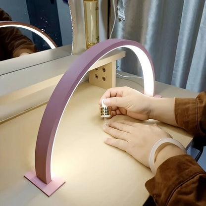LED desk lamp featuring an adjustable brightness and color temperature, designed with a sleek metal arch, USB powered for convenience. 3