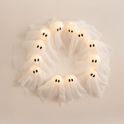 LED Ghost Wreath featuring battery-operated lights and spooky gauze accents, perfect for Halloween door decoration. 2