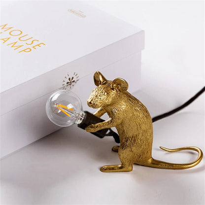 LED table lamp featuring a unique mouse design, crafted from durable white resin, providing warm lighting perfect for modern bedside or desk use. 4