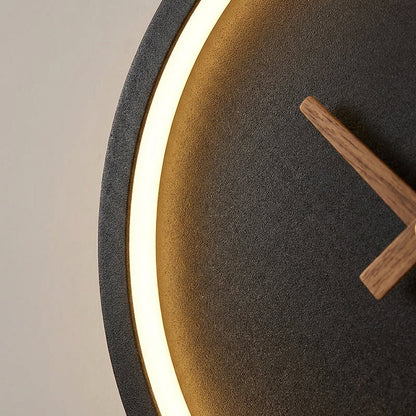 Modern minimalist LED wall clock featuring integrated warm white lighting, measuring 27x25cm, perfect for stylish home decor. 3