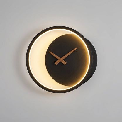Modern minimalist LED wall clock featuring integrated warm white lighting, measuring 27x25cm, perfect for stylish home decor. 2