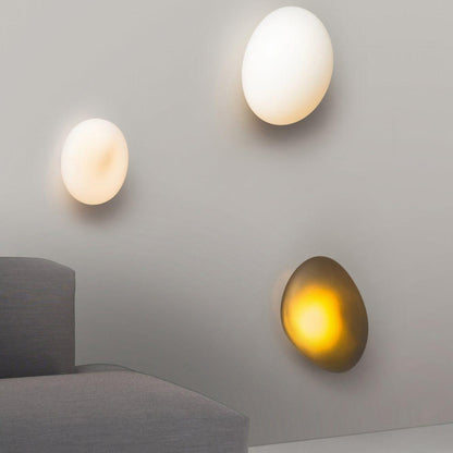 LED wall lamp featuring an adjustable light color, designed with a sleek oval shape in metal and glass, perfect for modern home decor. 7