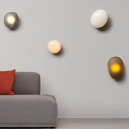 LED wall lamp featuring an adjustable light color, designed with a sleek oval shape in metal and glass, perfect for modern home decor. 3