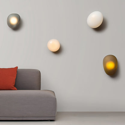 LED wall lamp featuring an adjustable light color, designed with a sleek oval shape in metal and glass, perfect for modern home decor. 1