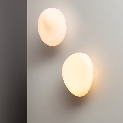 LED wall lamp featuring an adjustable light color, designed with a sleek oval shape in metal and glass, perfect for modern home decor. 2