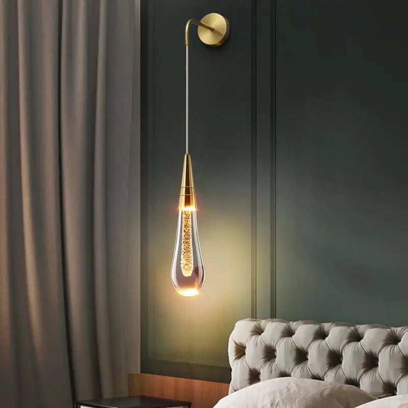 LED wall lamp featuring warm light and elegant gold accents, designed in a modern waterdrop shape with a combination of glass and metal materials, perfect for contemporary 0