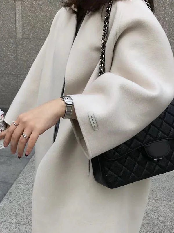 Long wool coat for women featuring a relaxed fit and minimalist design, perfect for autumn and winter fashion. 4