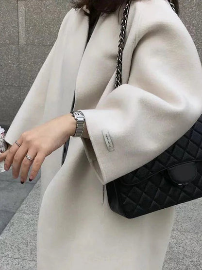 Long wool coat for women featuring a relaxed fit and minimalist design, perfect for autumn and winter fashion. 4