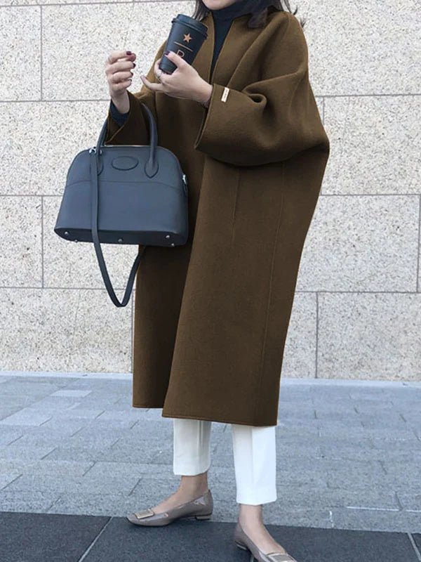Long wool coat for women featuring a relaxed fit and minimalist design, perfect for autumn and winter fashion. 8