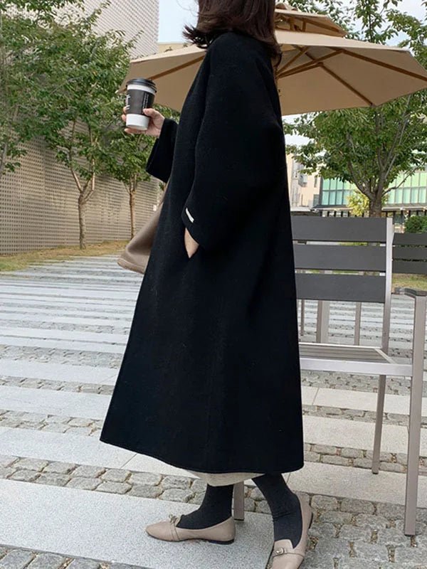 Long wool coat for women featuring a relaxed fit and minimalist design, perfect for autumn and winter fashion. 6