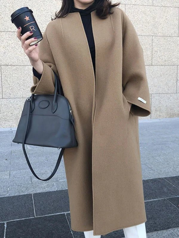 Long wool coat for women featuring a relaxed fit and minimalist design, perfect for autumn and winter fashion. 0