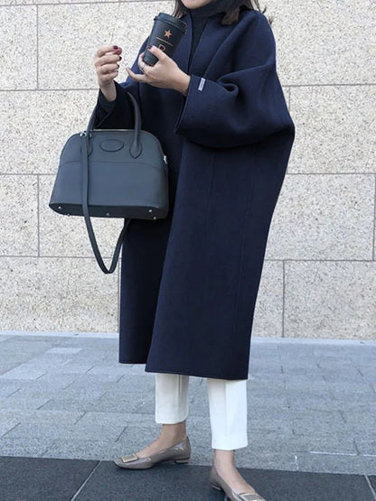 Long wool coat for women featuring a relaxed fit and minimalist design, perfect for autumn and winter fashion. 11