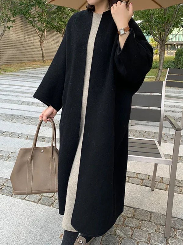 Long wool coat for women featuring a relaxed fit and minimalist design, perfect for autumn and winter fashion. 12