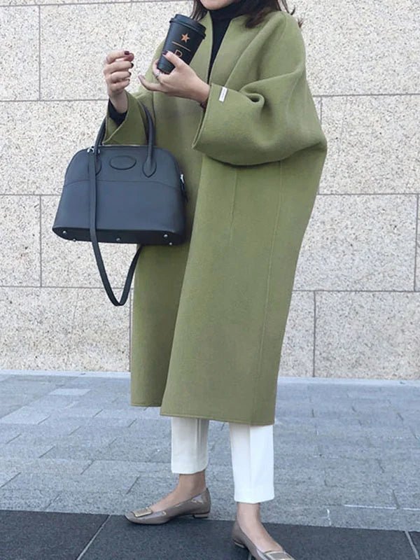 Long wool coat for women featuring a relaxed fit and minimalist design, perfect for autumn and winter fashion. 10