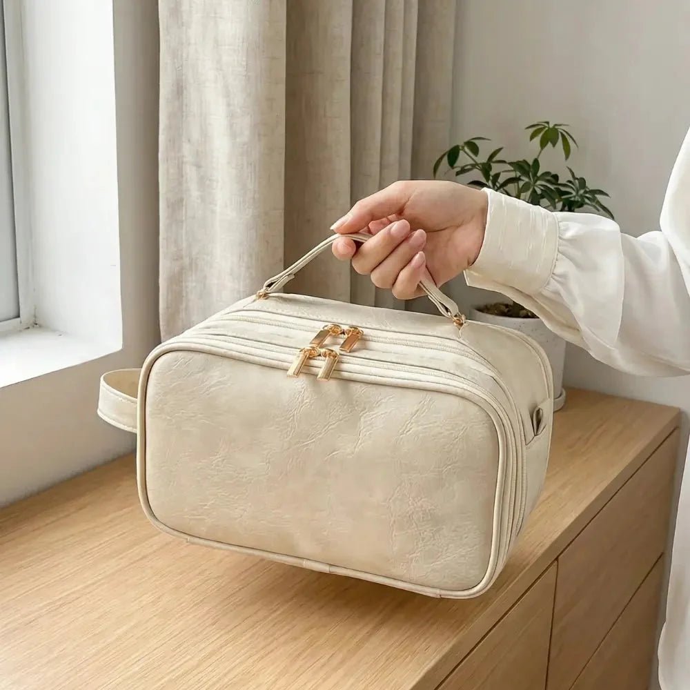 Makeup organizer bag featuring a dual-zip flat opening, brush holder, and waterproof PU leather design, perfect for travel and cosmetic storage. 1