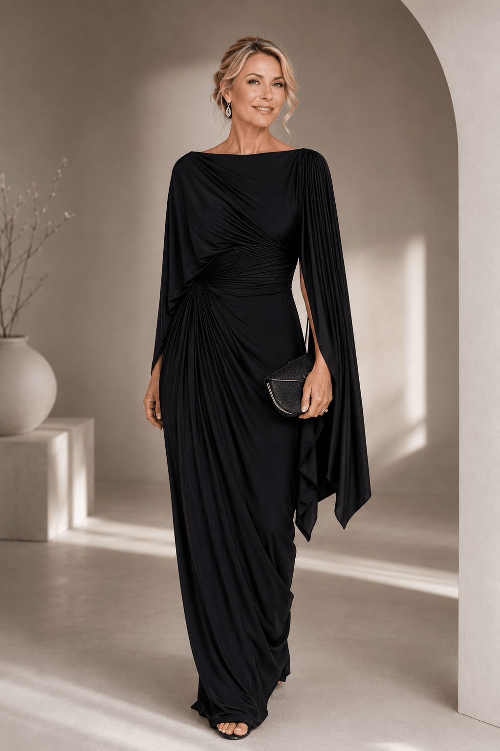 Elegant maxi dress featuring flowing cape sleeves and a ruched waist, perfect for formal occasions. 1