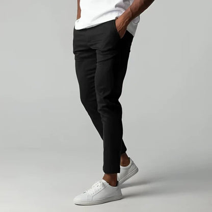 Men's slim fit chino pants with tapered leg design, made from stretch fabric for all-day comfort and style. 1