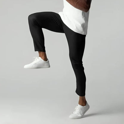 Men's slim fit chino pants with tapered leg design, made from stretch fabric for all-day comfort and style. 2