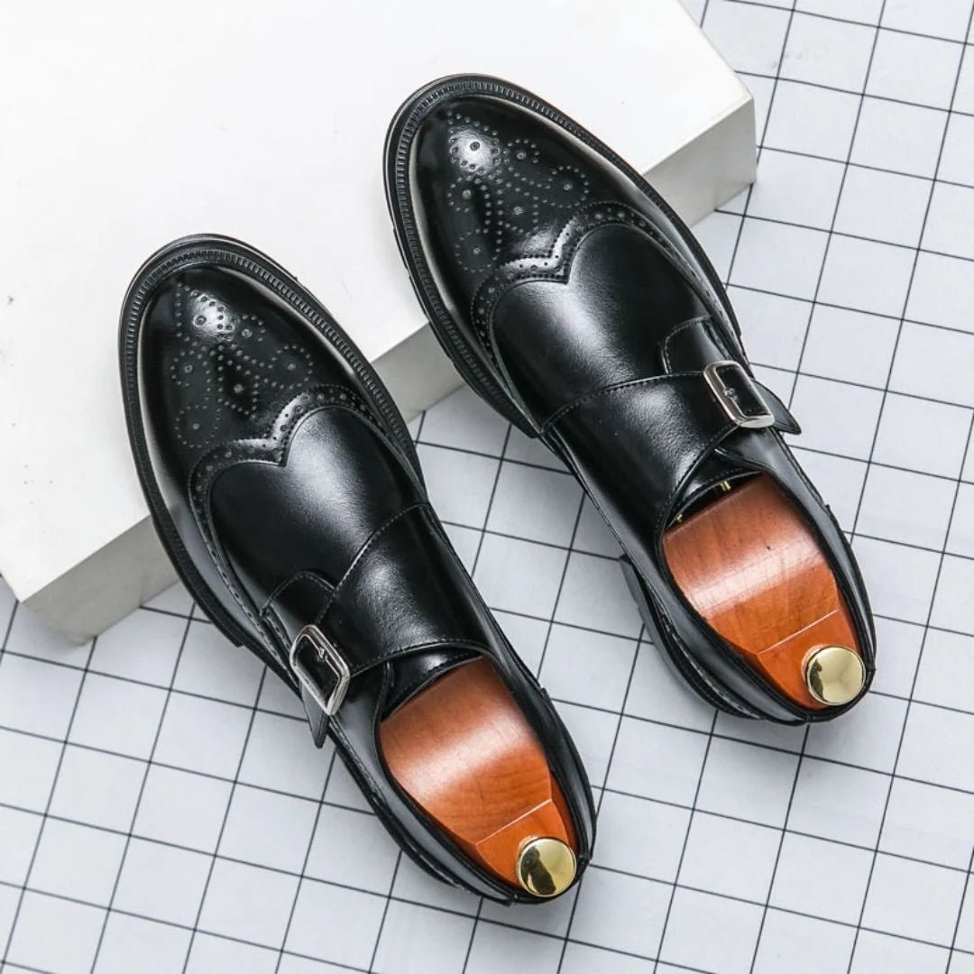 Men's black leather dress shoes featuring a single-buckle closure and intricate brogue detailing, designed in a stylish wingtip monk-strap style. 0