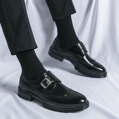 Men's black leather dress shoes featuring a single-buckle closure and intricate brogue detailing, designed in a stylish wingtip monk-strap style. 3