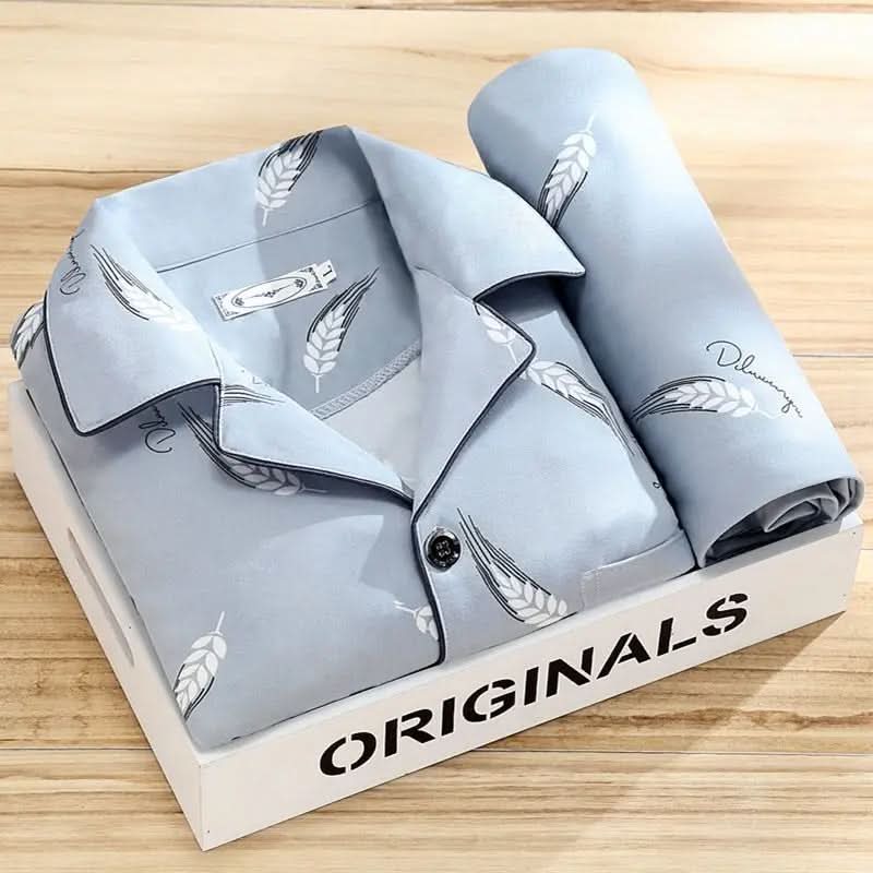 Men's pajama set featuring a button-down shirt and matching pants, designed for year-round comfort with soft, breathable fabric, ideal for restful sleep. 1