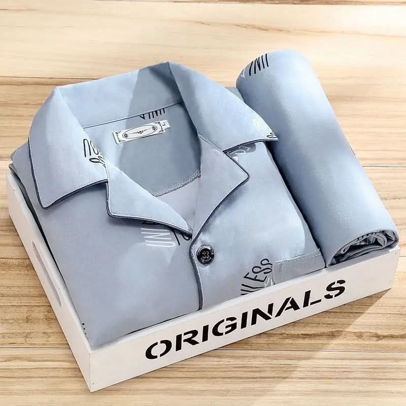 Men's pajama set featuring a button-down shirt and matching pants, designed for year-round comfort with soft, breathable fabric, ideal for restful sleep. 9