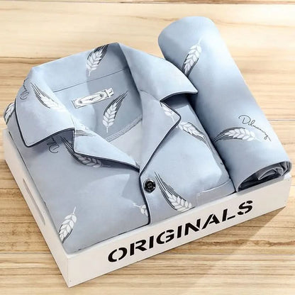 Men's pajama set featuring a button-down shirt and matching pants, designed for year-round comfort with soft, breathable fabric, ideal for restful sleep. 0