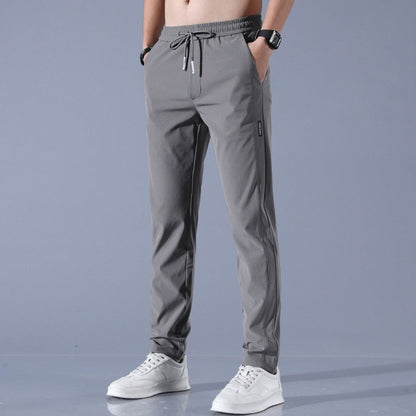 Men's quick-dry stretch trousers with drawstring, designed for comfort and flexibility in outdoor activities, featuring soft activewear fabric for optimal performance. 2