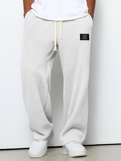 Men's trousers featuring an adjustable waistband and relaxed fit, made from breathable lightweight fabric, perfect for casual and smart wear. 2