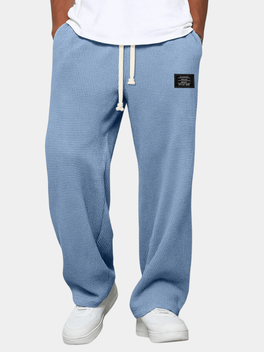 Men's trousers featuring an adjustable waistband and relaxed fit, made from breathable lightweight fabric, perfect for casual and smart wear. 1