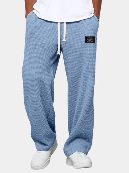 Men's trousers featuring an adjustable waistband and relaxed fit, made from breathable lightweight fabric, perfect for casual and smart wear. 1